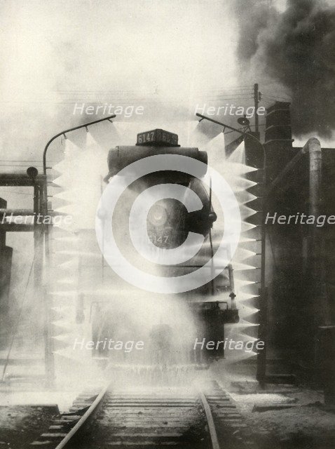 'Washing A Locomotive on the Canadian National Railway, at Montrea', 1935. Creator: Unknown.