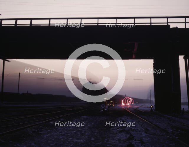 View in a departure yard at C & NW RR's Proviso (?) yard at twilight, Chicago, Ill., 1942. Creator: Jack Delano.