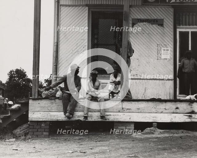 Negroes hanging around the plantation store. Mississippi Delta, 1936. Creators: Farm Security Administration, Dorothea Lange.