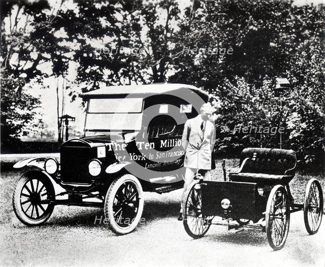 Henry Ford with old models of the Ford trademark.