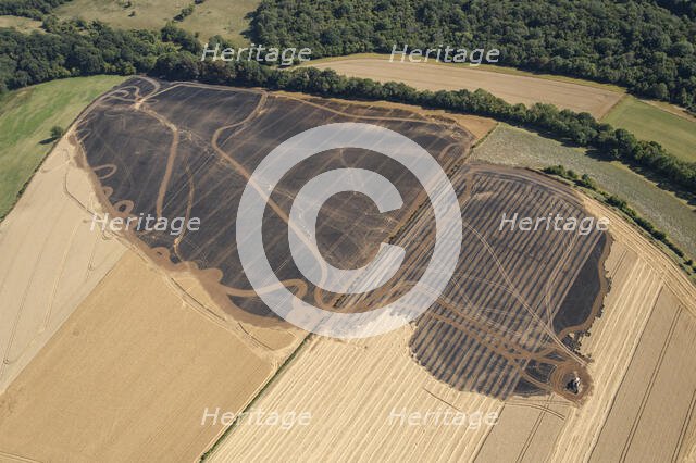 A burnt out combine harvester and fire scorched fields near Pleasley, Derbyshire, 2022. Creator: Emma Trevarthen.