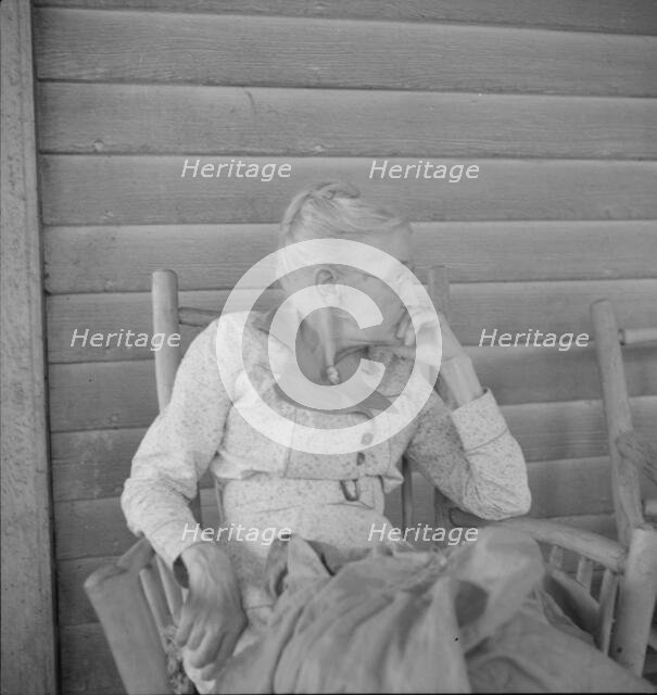 Southern lady of the old school on the veranda...of the Wray Plantation, Georgia, 1937. Creator: Dorothea Lange.