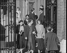 Workers Leaving Factory Through Factory Gates Which Are Closed After Them, 1932. Creator: British Pathe Ltd.