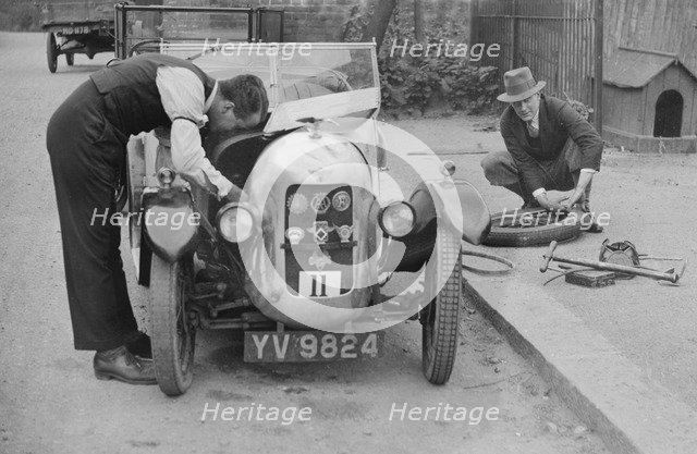 Working on the engine of E Martin's Austin Swallow at the North West London Motor Club Trial, 1929. Artist: Bill Brunell.