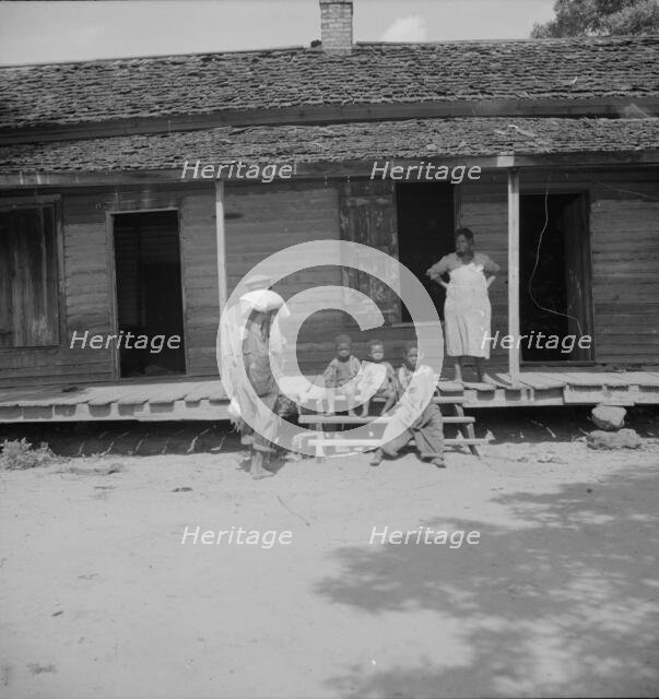 Negro wage laborer and part of his family, Macon County, Georgia, 1937. Creator: Dorothea Lange.