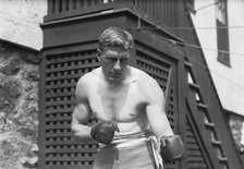 Bombardier Billy Wells, English boxer, preparing in Rye, N.Y., for fight with Al Panzer, 1912. Creator: Bain News Service.