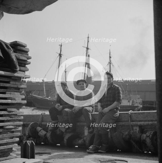 Gloucester fishermen resting on their boat at the Fulton fish market, New York, 1943. Creator: Gordon Parks.