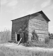 The old tobacco barn (new one under construction.), Chatham County, North Carolina, 1939. Creator: Dorothea Lange.