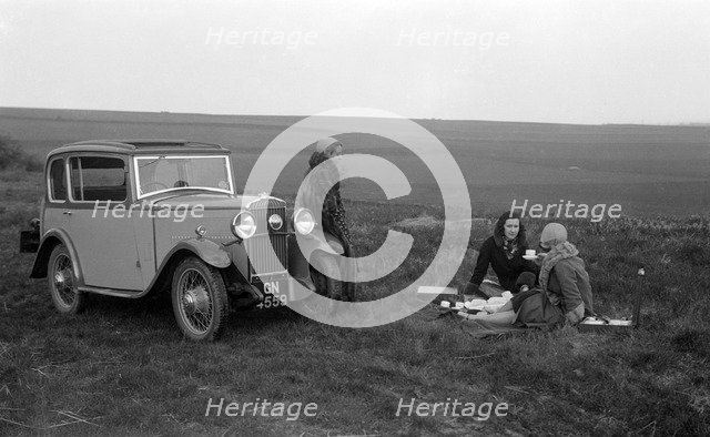 Three women having a picnic during a road test of a Triumph Scorpion, 1931. Artist: Bill Brunell.