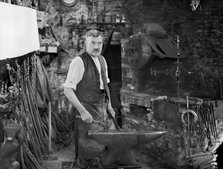 Mr Jefferies at work in the forge, Southrop, Cotswolds, Gloucestershire, 1938. Creator: Sydney Alfred Pitcher.