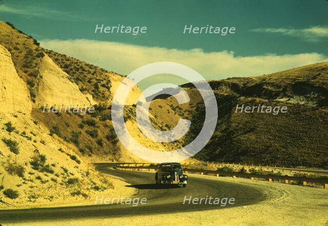 Road cut into the barren hills which lead into Emmett, Idaho, 1941. Creator: Russell Lee.