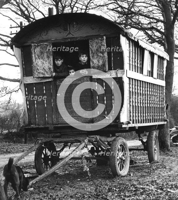 Gipsy children looking out of their caravan by the roadside, Charlwood, Surrey, 1964.