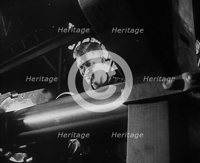 A Factory Worker Operating Machinery, 1943. Creator: British Pathe Ltd.
