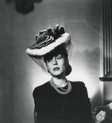 Woman wearing a hat and veil by the French fashion designer Jacques Fath, France, 1943. Artist: Unknown