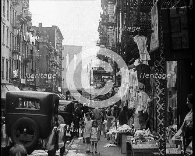Street View of Street Market Selling Clothes in New York City, 1932. Creator: British Pathe Ltd.