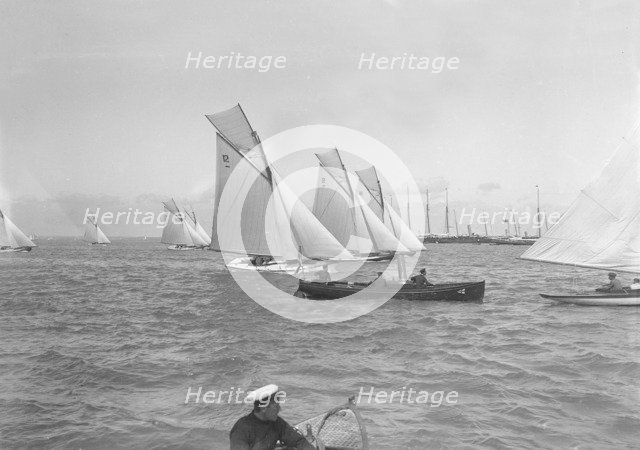 Sailing yachts cross start line. Creator: Kirk & Sons of Cowes.