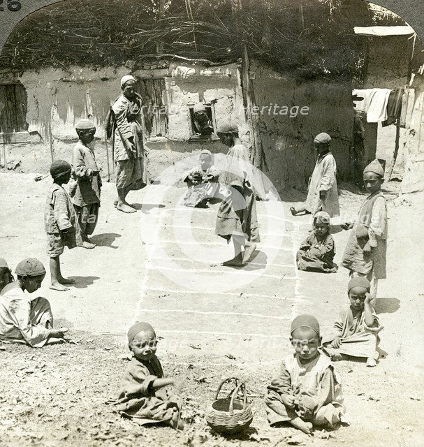 Children playing hopscotch, Kashmir, India, c1900s(?).Artist: Underwood & Underwood