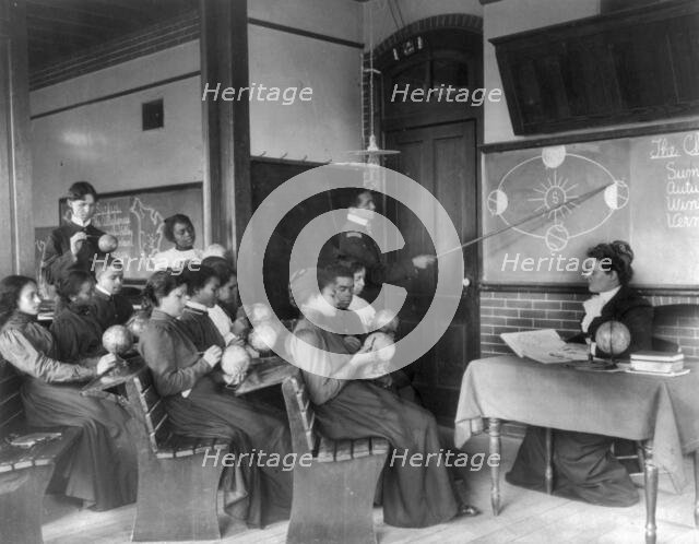 A class in mathematical geography studying earth's rotation..., Hampton Institute, Virginia, 1899. Creator: Frances Benjamin Johnston.