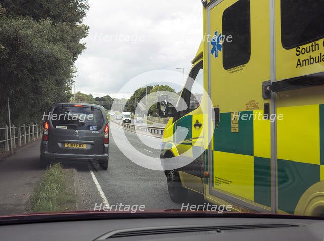 Ambulance attending road traffic accident, A35 Hampshire 2017. Creator: Unknown.