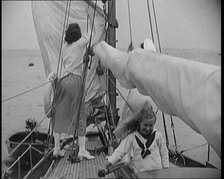 Female Civilians Wearing Summer Outfits and a Captain's Hat Onboard of a Boat Hoisting up a..., 1920 Creator: British Pathe Ltd.