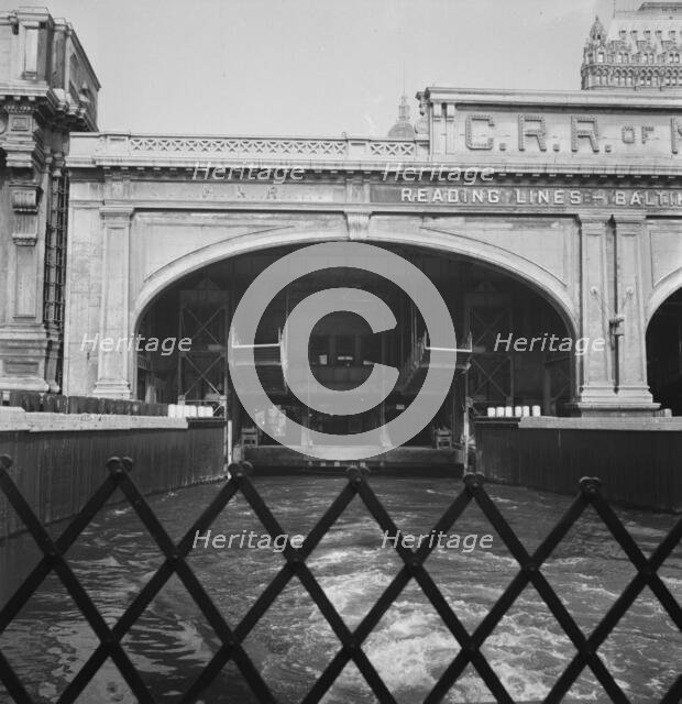 Ferry slip seen from ferry which transports passengers across the Hudson..., New York City, 1939. Creator: Dorothea Lange.