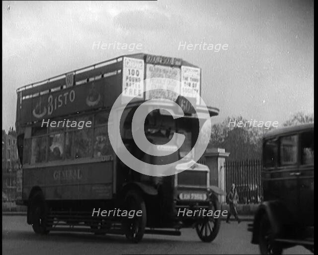 London Bus, Cars and Taxis Turning a Corner on a London Street, 1924. Creator: British Pathe Ltd.