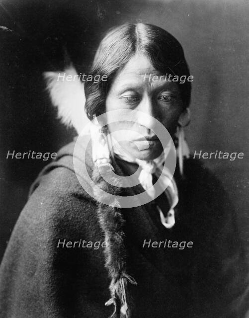 Jicarilla man, head-and-shoulders portrait, facing slightly right, with fur wrapped braids..., c1905 Creator: Edward Sheriff Curtis.