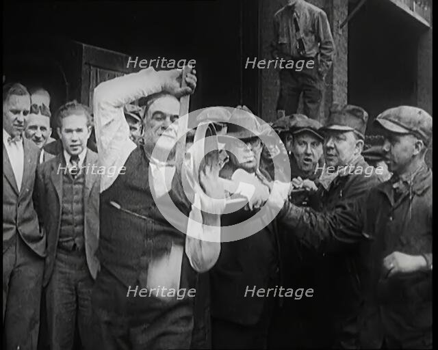 A Male Stuntman Bending Iron Bars Around His Head, 1926. Creator: British Pathe Ltd.