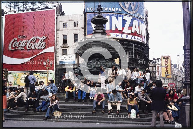 Crowds on the steps at the base of the Shaftesbury Memorial Fountain, Piccadilly Circus, 1974. Creator: Dorothy Chapman.