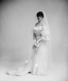 Woman in wedding dress holding flowers, between 1900 and 1910. Creator: Unknown.