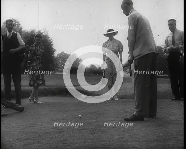 Men and Women at  the Golf Links With One Man Lining up His Shot, 1939. Creator: British Pathe Ltd.