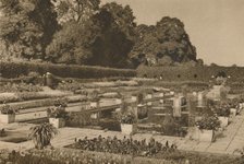 'The Quiet of the Dutch Garden at Kensington Palace Guarded By Locked Gates', c1935. Creator: Unknown.