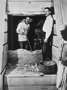Howard Carter and a colleague excavating a tomb in the Valley of the Kings, Egypt, 1922. Artist: Harry Burton