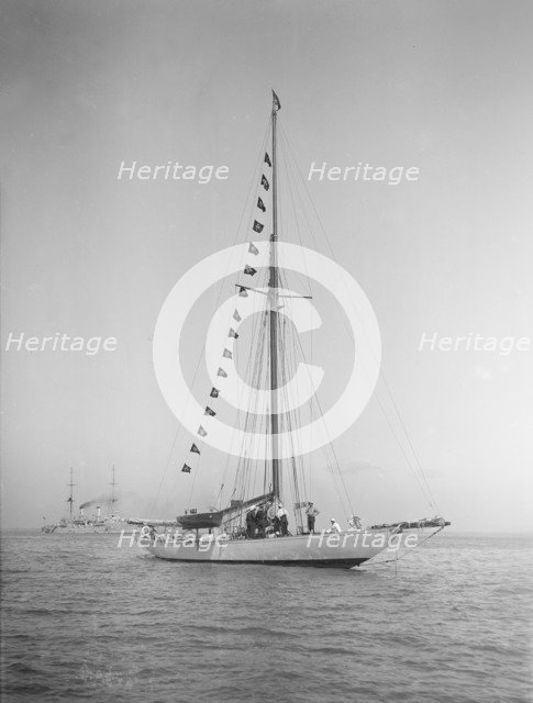 The 40-rater cutter 'Carina' at anchor with flags, 1911. Creator: Kirk & Sons of Cowes.