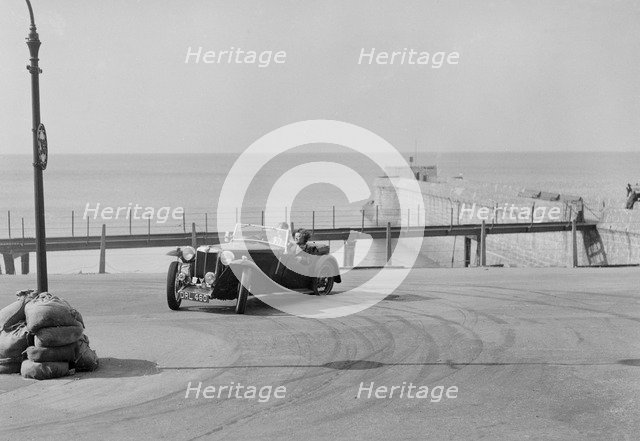 MG TA of FG Cornish competing in the RAC Rally, Madeira Drive, Brighton, 1939. Artist: Bill Brunell.