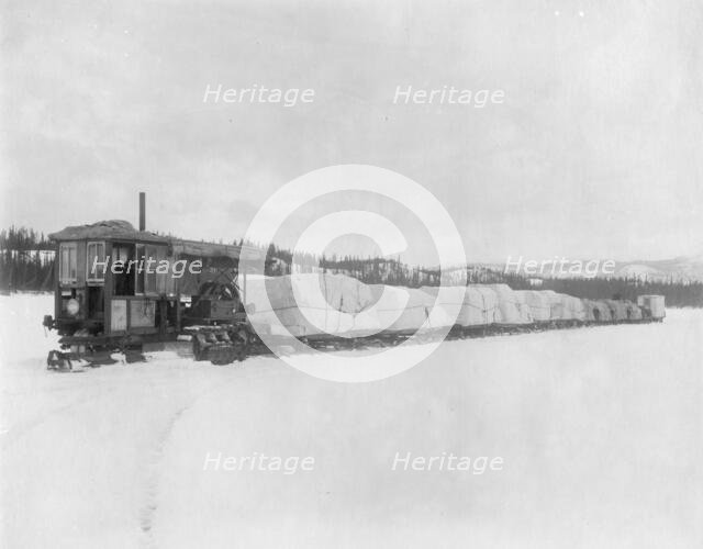 Caterpillar hauling freight on the lake in spring to the Yukon, between c1900 and c1930. Creator: Unknown.