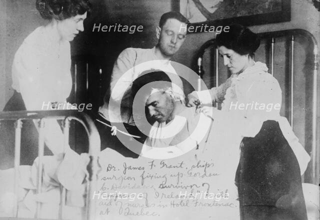 Dr. James F. Grant, ship's surgeon, fixing up Gordon G. Davidson, survivor of EMPRESS OF..., 1914. Creator: Bain News Service.
