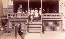 Bellevue Hospital, New York City: children patients, nurses and doctors sitting on a balcony in... Creator: Unknown.