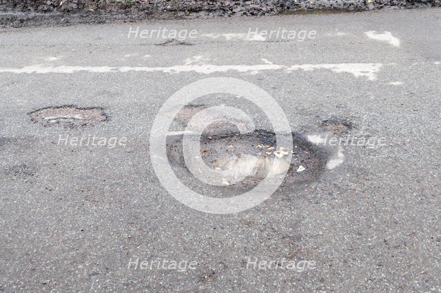 Pot holes in road surface 2017. Creator: Unknown.