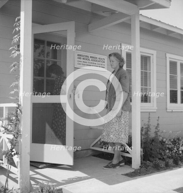Nurse's help with sick baby, FSA camp, Farmersville, Tulare County, California, 1939. Creator: Dorothea Lange.