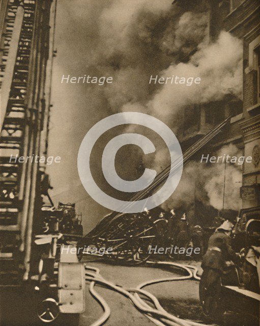 'Subduing a Conflagration in a Narrow City Street', c1935. Creator: Unknown.