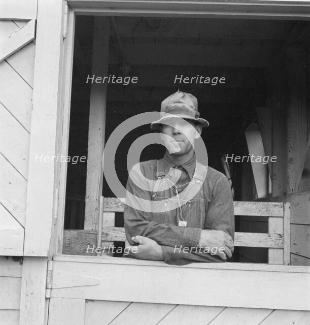 Mr. Granger, seen in doorway of his new barn, Yamhill County, Oregon, 1939. Creator: Dorothea Lange.