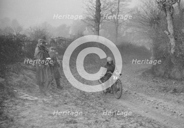 Woman riding a Royal Enfield motorcycle in the Gloucester Trial, c1930s. Artist: Bill Brunell.