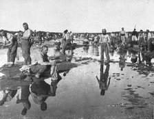 'Tandis que;..et d'autres se baignent sous un chaud soleil, dans l'oued Djedi, pres..., 1917. Creator: Unknown.