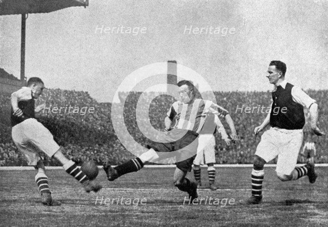 Action from an Arsenal v Sheffield United football match, c1927-1937.Artist: London News Agency