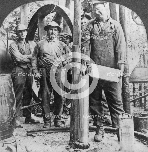 Filling a shell with nitro-glycerine, oil field in Pennsylvania, USA, early 20th century(?). Artist: Keystone View Company