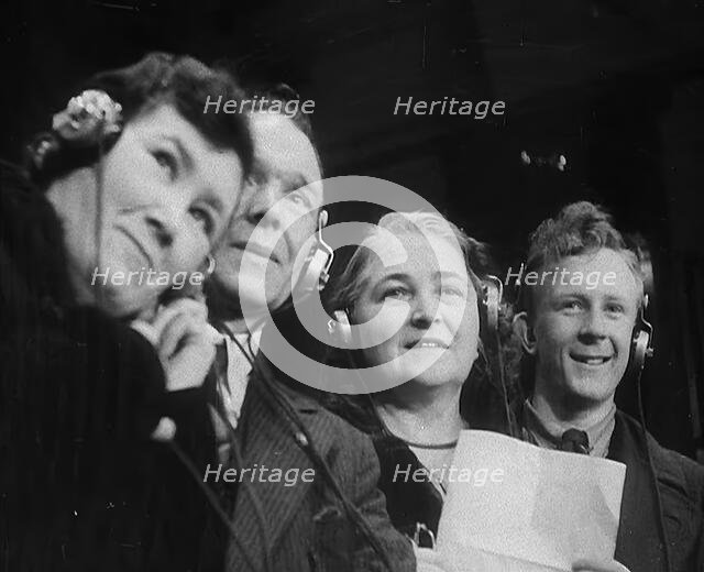 People Listening to Parents Calling Evacuee Children in America Over the Radio, 1940. Creator: British Pathe Ltd.