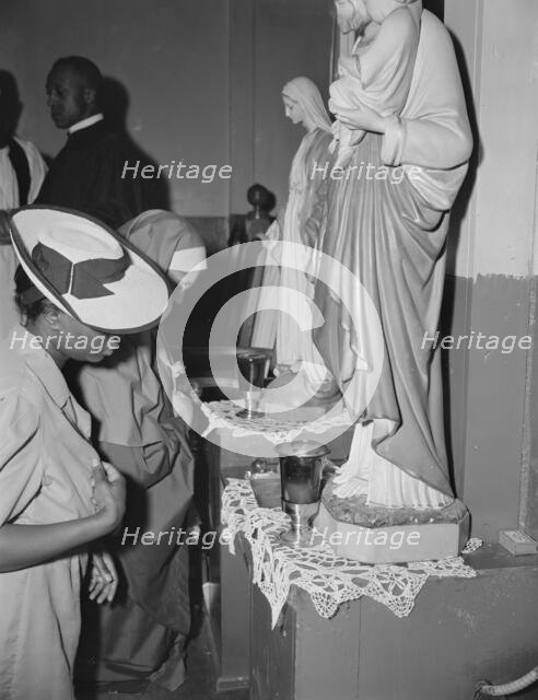 Worshippers before the altar in the St. Martin's Spiritual Church, Washington, D.C., 1942. Creator: Gordon Parks.