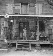 Daughter of white tobacco sharecropper at country store, Person County, North Carolina, 1939. Creator: Dorothea Lange.