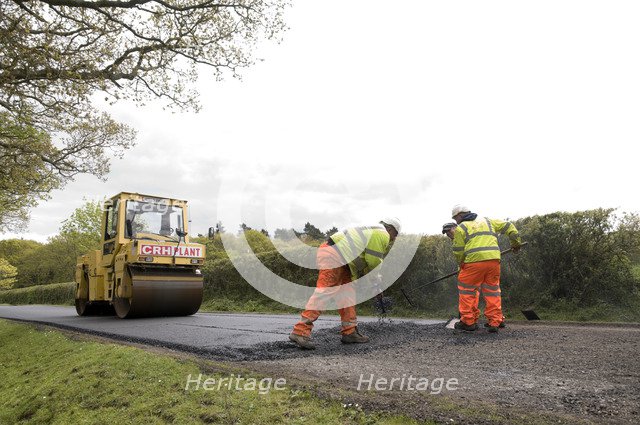 Road resurfacing work repairing potholes Artist: Unknown.